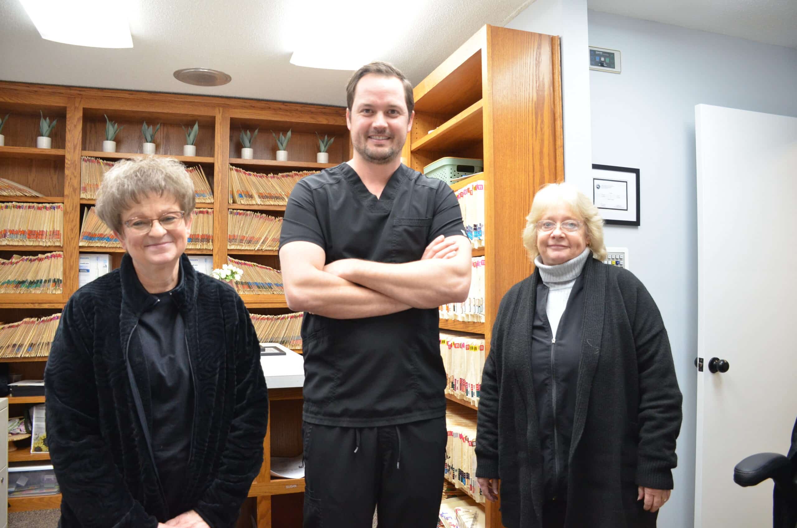 Male doctor showing x-ray pictures of teeth on tablet